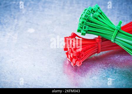 Bundle of self-locking cable ties on metallic background construction concept. Stock Photo