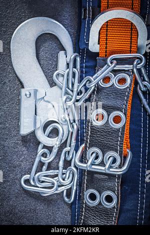Construction safety strap with metal chain on black background maintenance concept. Stock Photo
