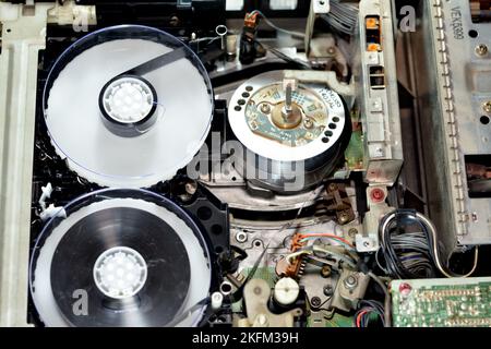 Cairo, Egypt, October 19 2022: Selective focus of the interior of an old obsolete VHS video recorder and player with its electronics and magnetic head Stock Photo