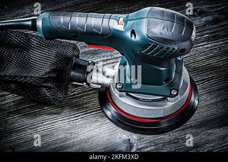 electric hand tool orbital sander on vintage wood Stock Photo