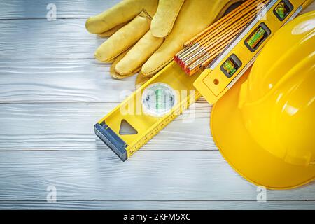Hard hat protective gloves construction level on white board. Stock Photo