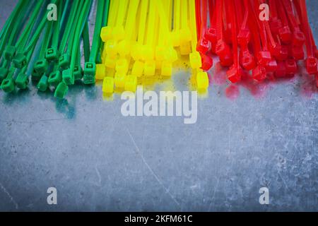 Heap of plastic cable ties on metallic background. Stock Photo