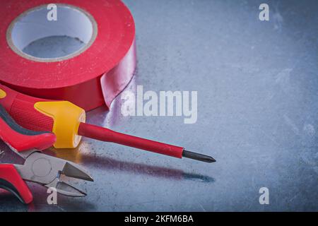 Insulation tape cutting pliers insulated screwdriver construction concept. Stock Photo