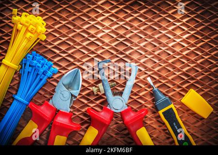 Insulation wire strippers cutter tying cables electric tester on dielectric mat. Stock Photo