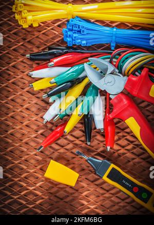 Insulation wire cutter tying cables electrical tester crocodile plugs on dielectric mat. Stock Photo
