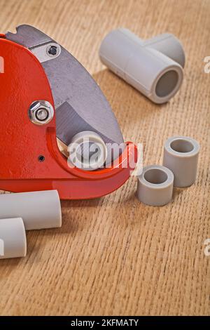 pipe cutter with cutted pipes on wooden boards close up Stock Photo