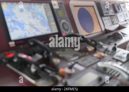 Navigational control panel and VHF radio. Working on the ship's navigational bridge. Blurred image. Stock Photo