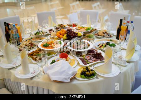 Beautifully served banquet table with a variety of snacks at corporate dinner, birthday party, Christmas party or wedding celebration. Stock Photo