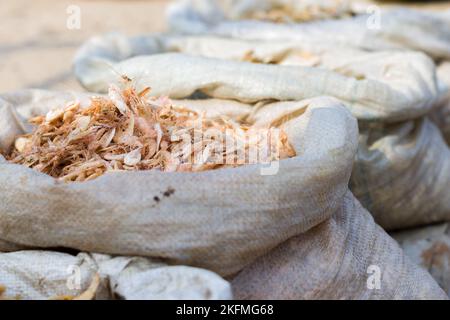 dried shrimps or krills kept in a sack in fish markets of india. Stock Photo