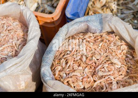 dried shrimps or krills kept in a sack in fish markets of india. Stock Photo