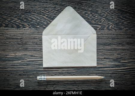 Vintage envelope letter pencil on black board. Stock Photo