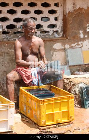 Man cleaning Athangudi tile in Attangudi,Tamil Nadu,India . Stock Photo