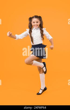 Keep going. Active kid. Girl on way knowledge. Knowledge day. Back to school. Kid cheerful schoolgirl running. Pupil want study. Active child in Stock Photo
