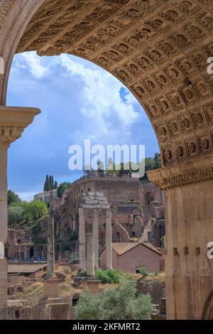 View of the Roman Forum through the Triumphal Arch of Septimius Severus in Rome, Italy. Stock Photo