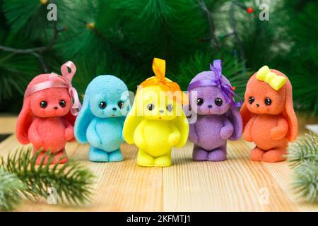 Handmade soap in the form of bright cute bunnies and rabbits in a New Year's atmosphere. Stock Photo