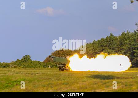 U.S. Army Soldiers assigned to Baker Battery, 3rd Battalion, 321st Field Artillery Regiment (3-321 FAR), 18th Field Artillery Brigade, fires a Reduced-Range Practice Rocket (RRPR) from an M142 High Mobility Artillery Rocket System during a Latvian-led field artillery live fire exercise, NAMEJS, at Liepāja, Latvia, Sept. 27, 2022. The 3-321 FAR is among other units assigned to the 1st Infantry Division, proudly working alongside NATO allies and regional security partners to provide combat-credible forces to V Corps, America's forward deployed corps in Europe. Stock Photo