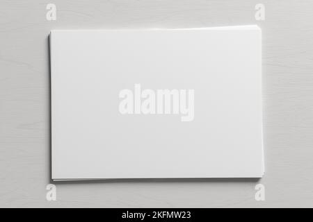 Stack of paper mockup on the white wooden table Stock Photo