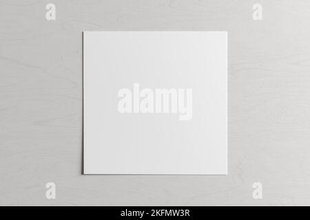 Square sheet of paper on the white wooden table Stock Photo