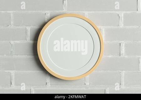 Wooden round frame poster mock up on the  white brick wall. Front view Stock Photo