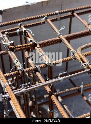 Reinforcement steel frame close up photo. Construction project in details. Stock Photo