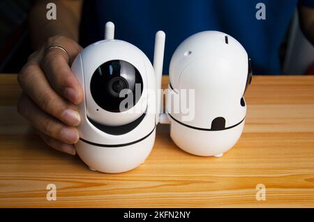Conceptual man operating ip camera,White IP cameras, very popular for security purposes. Stock Photo