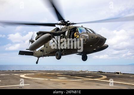 Sea of Japan (Sept. 28, 2022) U.S. Army UH-60 Black Hawk assigned to the 2nd Combat Aviation Brigade conducts flight deck operations aboard Ticonderoga-class guided-missile cruiser USS Chancellorsville (CG 62) in the Sea of Japan on Sept. 28, 2022. Chancellorsville is forward-deployed to the U.S. 7th Fleet in support of security and stability in the Indo-Pacific and is assigned to Commander, Task Force 70, a combat-ready force that protects and defends the collective maritime interest of its allies and partners in the region. Stock Photo