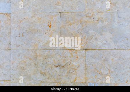 The texture of the wall lined with marble tiles Stock Photo
