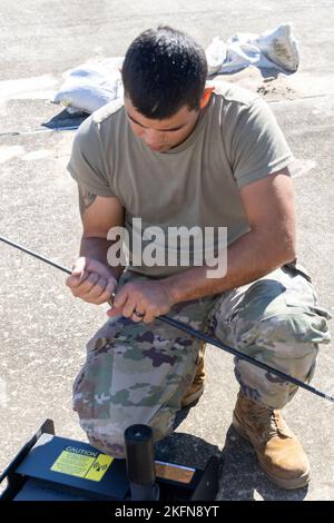 Airmen with the 255th Air Control Squadron, 172nd Airlift Wing, Mississippi Air National Guard, inspect and pack equipment at the Gulfport Combat Readiness Training Center, Gulfport, Miss., September 28, 2022. The Airmen are preparing to deploy to Florida in support of Hurricane Ian recovery. Stock Photo