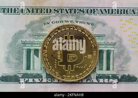 Bitcoin coin on dollar bill closeup Stock Photo