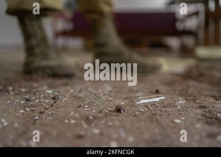 Nuclear apocalypse survivor, soldier in the destroyed laboratory building, legs close-up. nuclear and chemical danger, environmental disaster Stock Photo