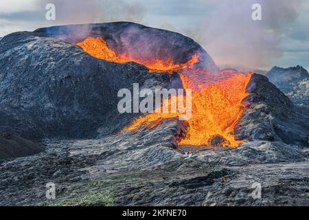 Active volcano about to erupt. strong lava flow from crater opening. Volcanic crater in Iceland. Volcanic landscape of Reykjanes Peninsula. Landscape Stock Photo