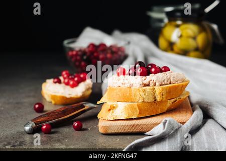 Baguette with goose liver pate and cranberries. Stock Photo