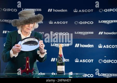 Ascot, Berkshire, UK. 19th November, 2022. Camilla, Queen Consort was at Ascot Racecourse today where she did the winners presentation for the Coral Hurdle Race which was won by horse Goshen ridden by jockey Ryan Moore. The Queen Consort looked elegant in a green winter coat and fur trimed green hat as she chatted to owner Steven Packham. Credit: Maureen McLean/Alamy Live News Stock Photo
