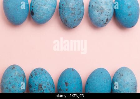 Blue Easter Eggs in a Row Forming a Frame on Pink Background with Copy Space Stock Photo