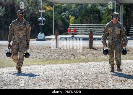 Staff Sgt. Caleb Stinson and Sergeant 1st Class Jason Pate, 68W Combat Medic, 232nd Medical Battalion, carry kettlebells before the stress shoot during the Best Medic Competition, Sep. 29, 2022 at Joint Base San Antonio-Camp Bullis, Tx. During the competition, two-soldier teams navigate a grueling series of events that push their stress, physical, and emergency medical skills to the limits. Among the many challenges the competitors face are an obstacle course, a physical fitness challenge, land navigation, and stress shoots on a firing range, which test their ability to fight despite difficult Stock Photo
