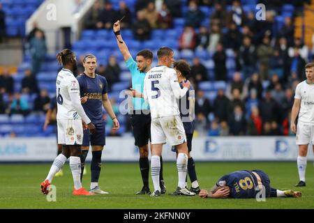 Dynel Simeu of Tranmere Rovers (l) receives a straight red card and is sent off by referee Thomas Kirk for a foul on Harry Pell of AFC Wimbledon. EFL Skybet Football league two match, Tranmere Rovers v AFC Wimbledon at Prenton Park, Birkenhead, Wirral on Saturday 19th November 2022. this image may only be used for Editorial purposes. Editorial use only, license required for commercial use. No use in betting, games or a single club/league/player publications.pic by Chris Stading/Andrew Orchard sports photography/Alamy Live News Stock Photo