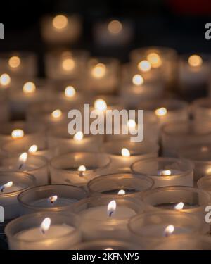 Votive candles lit in church Stock Photo