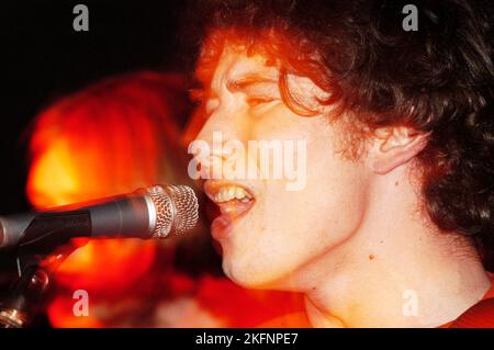 Craig Macintosh (Mackintosh) singer and guitarist with DOGS DIE IN HOT CARS at Cardiff Welsh Club, Wales UK on February 5 2004. Picture ROB WATKINS. INFO: Dogs Die In Hot Cars, a Scottish indie rock band, gained attention in the early 2000s. Their debut album, 'Please Describe Yourself,' showcased a mix of catchy pop melodies and eclectic influences. Despite their short-lived mainstream success, the band left a mark with their energetic and distinctive sound. Stock Photo