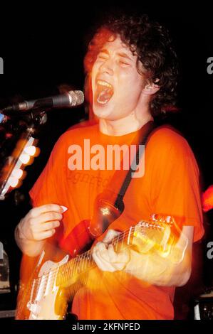 Craig Macintosh (Mackintosh) singer and guitarist with DOGS DIE IN HOT CARS at Cardiff Welsh Club, Wales UK on February 5 2004. Picture ROB WATKINS. INFO: Dogs Die In Hot Cars, a Scottish indie rock band, gained attention in the early 2000s. Their debut album, 'Please Describe Yourself,' showcased a mix of catchy pop melodies and eclectic influences. Despite their short-lived mainstream success, the band left a mark with their energetic and distinctive sound. Stock Photo