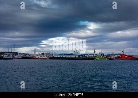 Reykjavik, Iceland - November 10, 2022: Cargo ships  and tourist boats moored at Reykjavik old harbour. Stock Photo