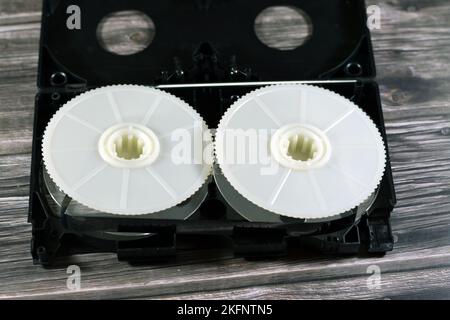 VHS video cassette tape from inside with the front casing removed showing supply and take up reels and is made of plastic that was used on video recor Stock Photo