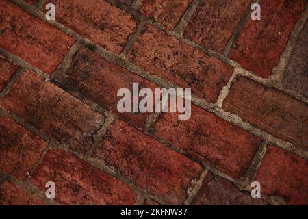 a dark red aged brick floor Stock Photo