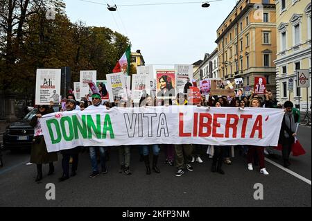 Milan, Italy - November 19, 2022: People rally in in support of the people of Iran and the worldwide protest following the death of Mahsa Amini, 22, died on September 16, following her arrest by Iran's morality police for allegedly breaching the dress code for women. Stock Photo