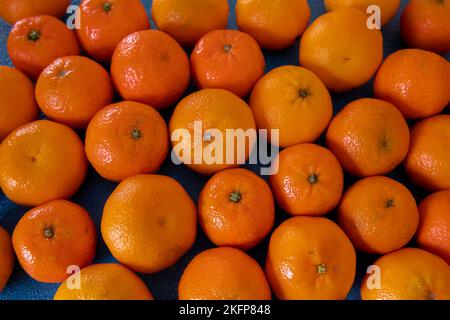 Tangerines lie on a blue background Stock Photo