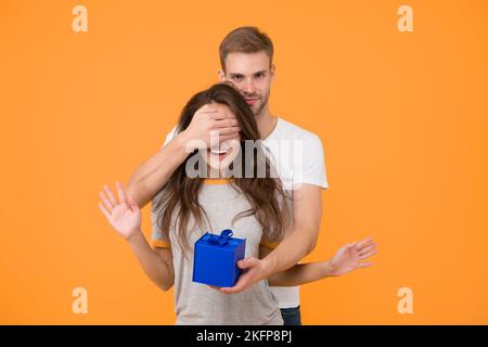 Blind surprise. Special day. Happiness is real. Happy birthday. Man give box to birthday girl. Birthday anniversary. Couple in love. Holiday Stock Photo