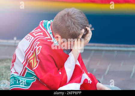 England fan wrapped in flag crying sad Final of the Champions League 2018, Kiev on May 26 Stock Photo