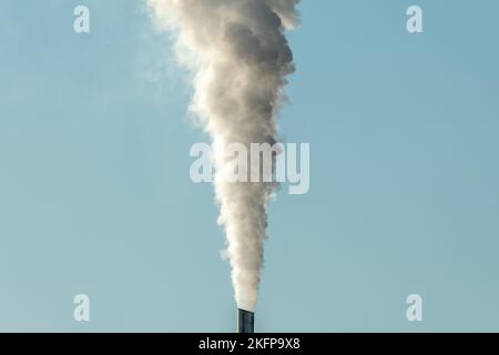 Column of smoke coming out of an industrial chimney. France. Stock Photo