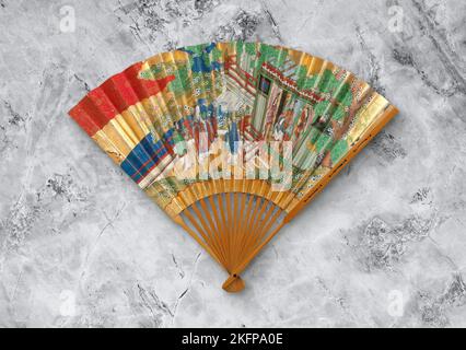 Old Japanese folding fan from early 19th century on gray background, real ancient decorative accessory Stock Photo