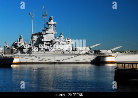 The USS Massachusetts, a US Navy South Dakota class Battleship, is moored as a museum at the Fall River Heritage State park with other naval ships Stock Photo