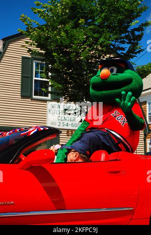 Wally, the Green Monster, the mascot of the Boston Red Sox, waves to the crowd during a parade on the Fourth of July Stock Photo